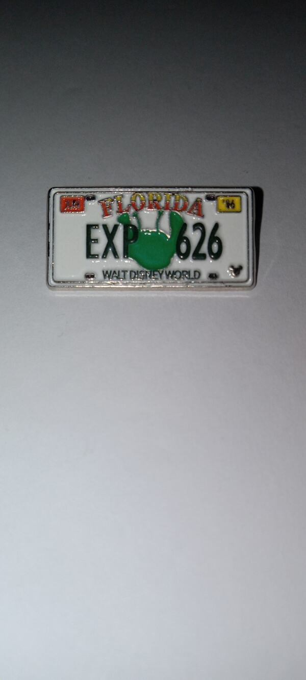 Disney license plate cast lanyard pin.